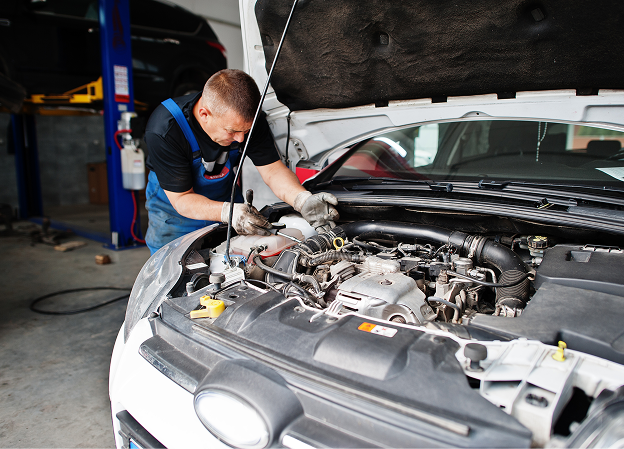 Professional mechanic inspecting a car engine at Big South Performance automotive service shop